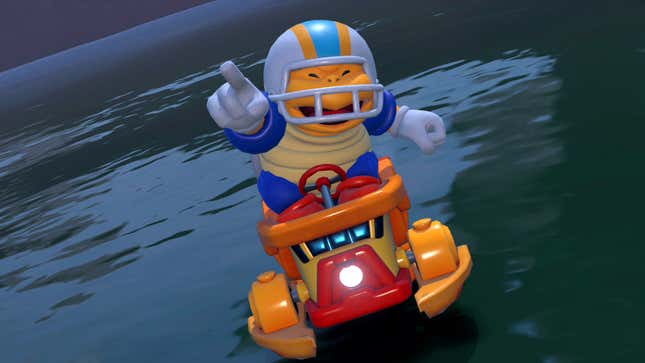 Chargin' Chuck holds up a hand while racing on a water vehicle.